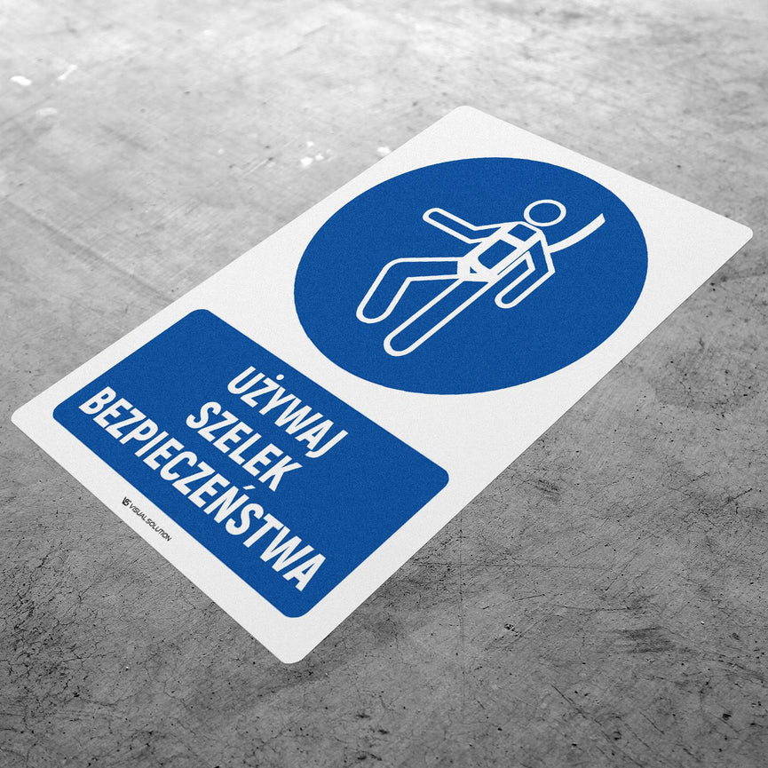 Naklejka podłogowa BHP: Nakaz używania szelek bezpieczeństwa z opisem.